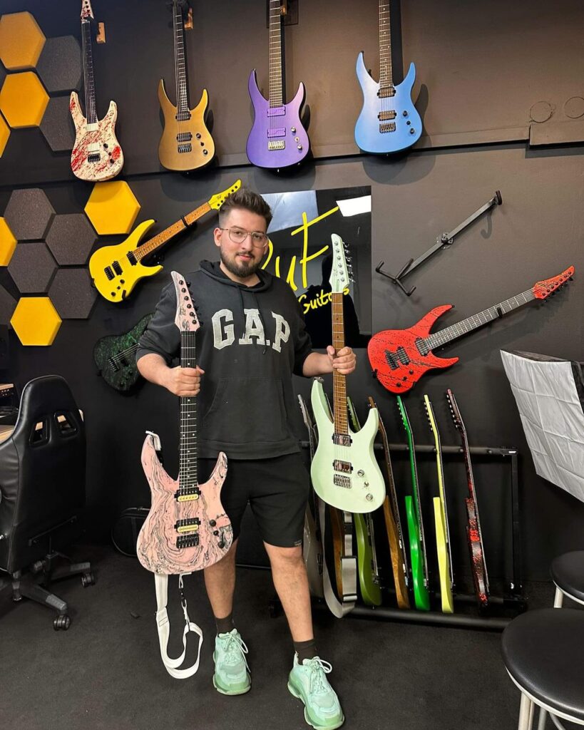 Jakub Laszuk holding two Ruf guitars