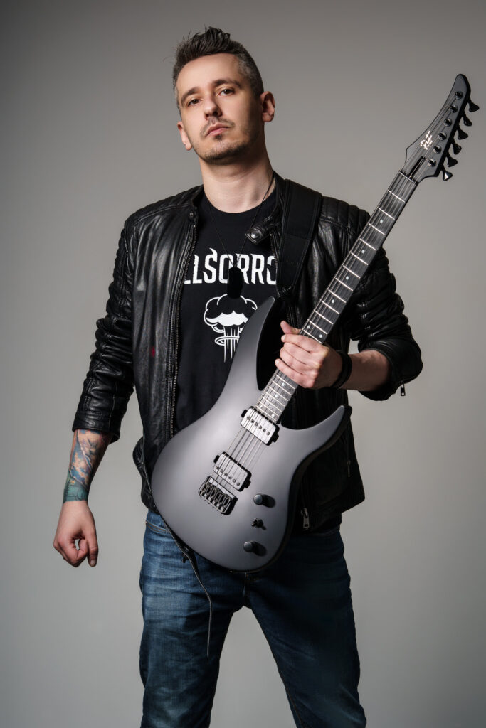 Krystian Manda holding black Ruf guitar